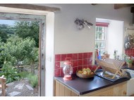 The kitchen and view to the garden. Photo from Under the Thatch