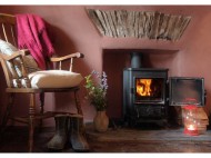 Parlour with wood burner. Photo by Under the Thatch