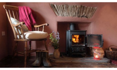 Parlour with wood burner. Photo by Under the Thatch