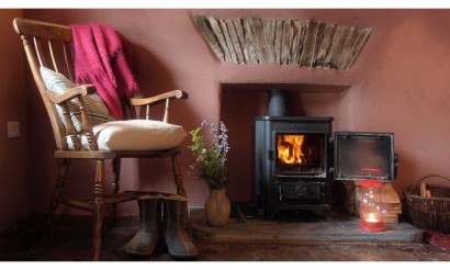 Parlour with wood burner. Photo by Under the Thatch